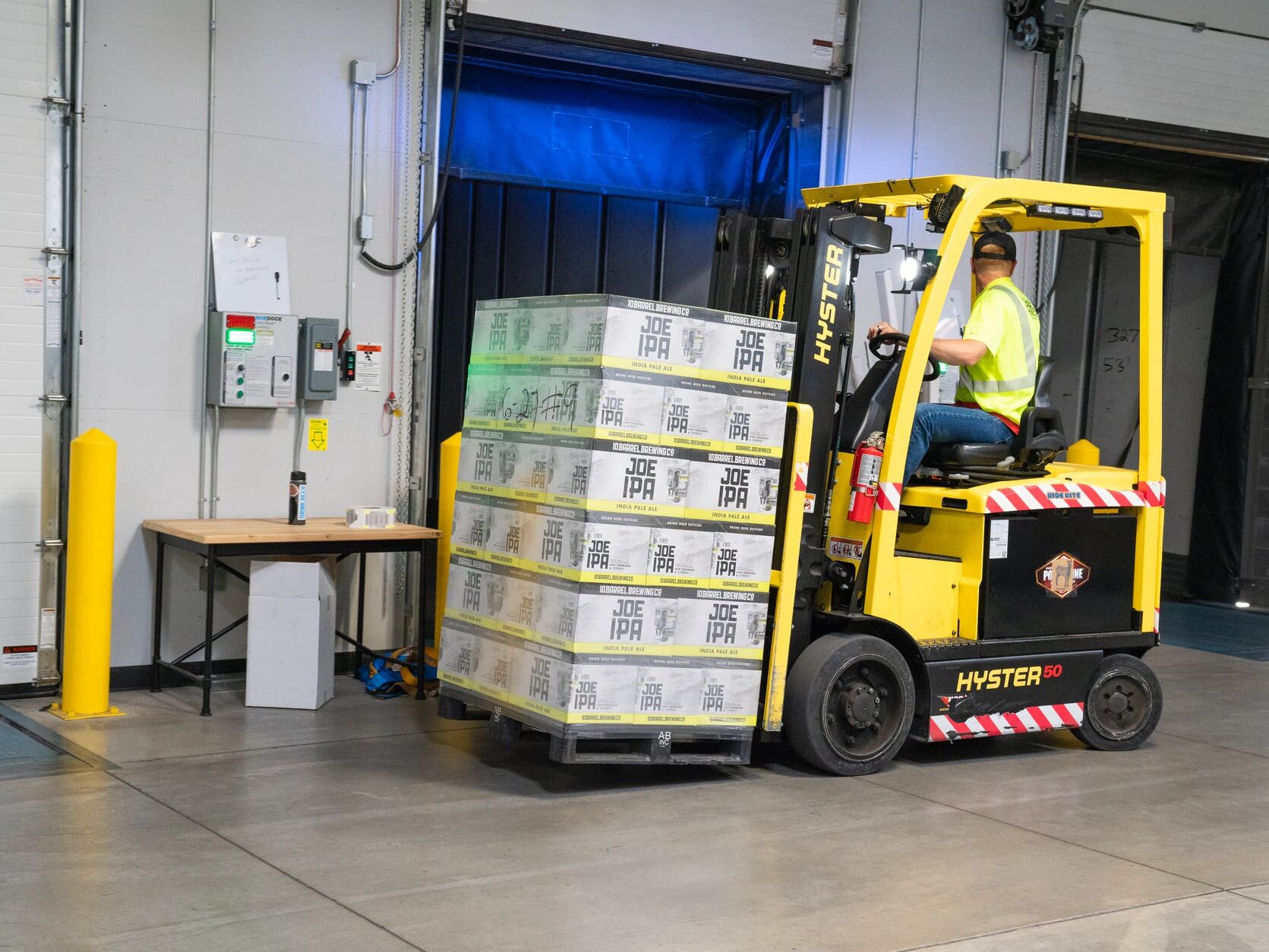 man riding on yellow forklift